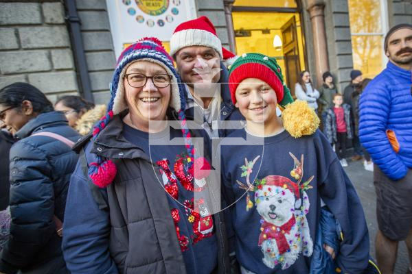 Picture by Sophie Rabey.  25-11-23.  Father Christmas comes to St Peter Port town to switch on the Christmas lights 2023.
L-R Ann Thomson, Paul Clark and George Clark (11)