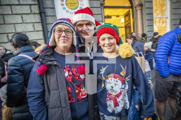 Picture by Sophie Rabey.  25-11-23.  Father Christmas comes to St Peter Port town to switch on the Christmas lights 2023.
L-R Ann Thomson, Paul Clark and George Clark (11)
