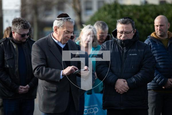Picture by Tom Videlo. 27-01-24 A member of the Jewish community reads the Mourner's Kaddish at the Holocaust Memorial Day service at the White Rock.