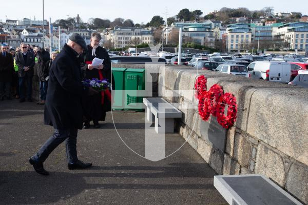 Picture by Tom Videlo. 27-01-24 Deputy Jonathan Le Tocq lays a wreath at the Holocaust Memorial Day service at the White Rock.