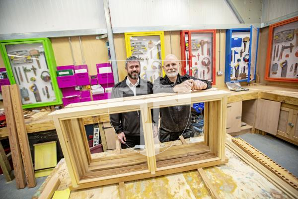 Picture by Sophie Rabey.  29-01-24.  Feature on Education in Guernsey Prison.
Woodwork crafts that prisoners have made in the main carpentry workshop.  L-R Prison Officer of Regimes Matt Chick and CLIP Workshop Officer, Officer Birkett, behind some window frames that the prisoners have been learning to make.