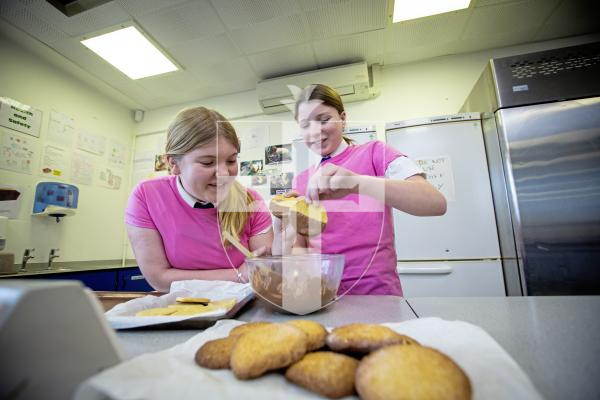 Picture by Peter Frankland. 31-01-24 St. Sampson's High School are running extra-curricular activities for students during lunchtimes. Cookery Club. L-R - Maisie Harris, 14 and Rosie McClean, 14 making cookies.