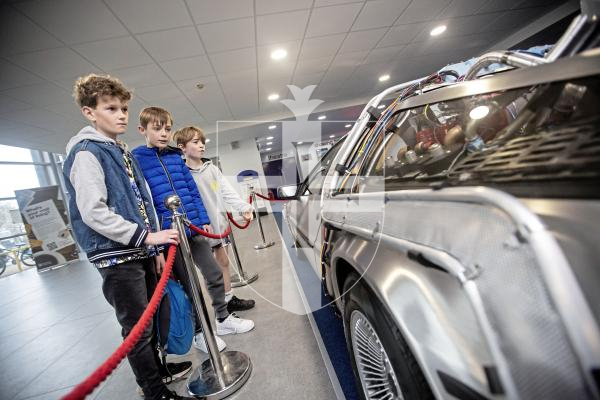Picture by Peter Frankland. 04-02-24 Screening of Back to the Future at Beau Sejour. A replica De Lorian time machine is over. L-R - Oliver Blundell, 11, Idris Rees, 11 and Charlie Dowding, 10.
