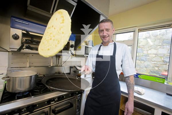 Picture by Peter Frankland. 06-02-24 Guernsey Cheshire Home is getting ready for the Town Church Pancake Day event next week. Chef Calum Gleeson flipping a pancake.