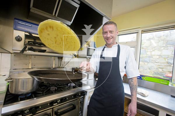 Picture by Peter Frankland. 06-02-24 Guernsey Cheshire Home is getting ready for the Town Church Pancake Day event next week. Chef Calum Gleeson flipping a pancake.