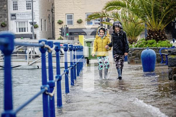 Picture by Peter Frankland. 13-02-24 A nearly 10m high tide in St. Peter Port caused a little flooding . L-R - Seren Jones, 7 and Finlay Jones, 9.