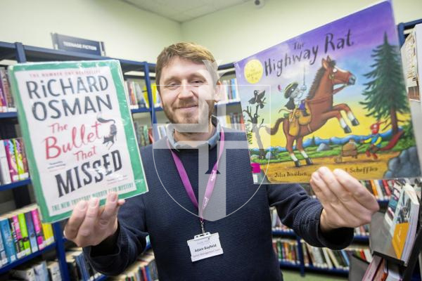 Picture by Peter Frankland. 13-02-24 Guille-Alles Library.  Adam Bayfield with the library's two most popular adult and children's books.