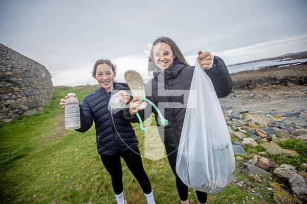 Picture by Peter Frankland. 13-02-24 Litter pickers who have collected loads of waste from the shore around Lihou Island. L-R - Peyton Fletcher, 11 and Lexi Fletcher, 13 were out for a family walk and collected a bag of rubbish on their way.