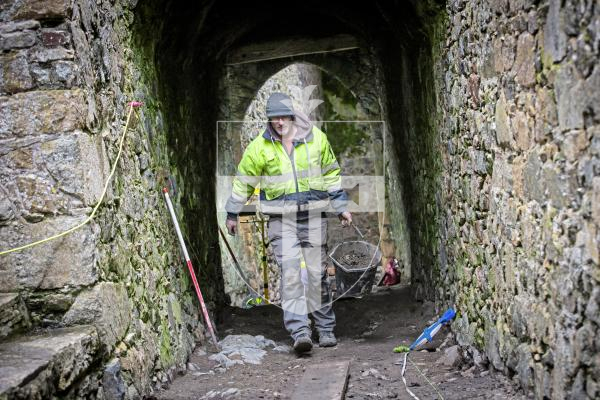 Picture by Peter Frankland. 22-02-24 Update on the state of the archaeological dig taking place at Castle Cornet. The team have made some interesting discoveries. Andy Lane carrying another bucket load of earth out of the trench.