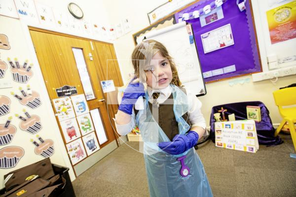 Picture by Sophie Rabey.  26-02-24.   ICU nurse, Tiffany Le Boutillier, visited reception children at St Mary & St Michael's school to talk about how she enjoys her career of being a nurse.  The children had a chance to try out some equipment.
Etta Langlois (aged 5) with an Ear Thermometer.