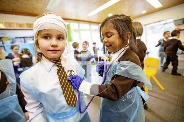 Picture by Sophie Rabey.  26-02-24.   ICU nurse, Tiffany Le Boutillier, visited reception children at St Mary & St Michael's school to talk about how she enjoys her career of being a nurse.  The children had a chance to try out some equipment.
L-R Lana Viera (aged 4) and Ella Pather-Jacob (aged 5) using a stethoscope.