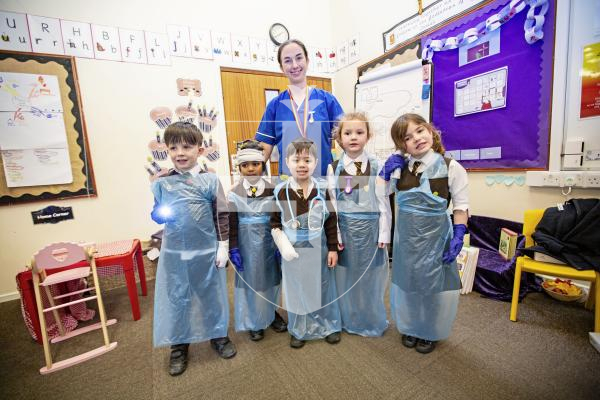 Picture by Sophie Rabey.  26-02-24.   ICU nurse, Tiffany Le Boutillier, visited reception children at St Mary & St Michael's school to talk about how she enjoys her career of being a nurse.  The children had a chance to try out some equipment.
L-R Ezra Rumens (5), Ella Pather-Jacob (5), Ethan Gardner (4), Lailee Loveridge (5) and Etta Langlois (5), with ICU nurse, Tiffany Le Boutillier.