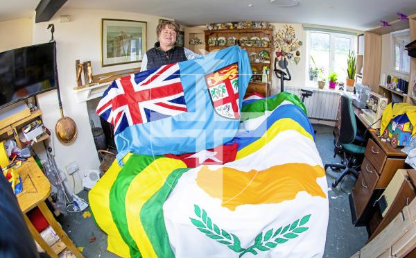 Picture by Peter Frankland. 05-03-24 Rose Yates of Sarnia Flags is making the Commonwealth flags which will be flown from the Weighbridge mast on Monday. Holding the flag of Fiji.