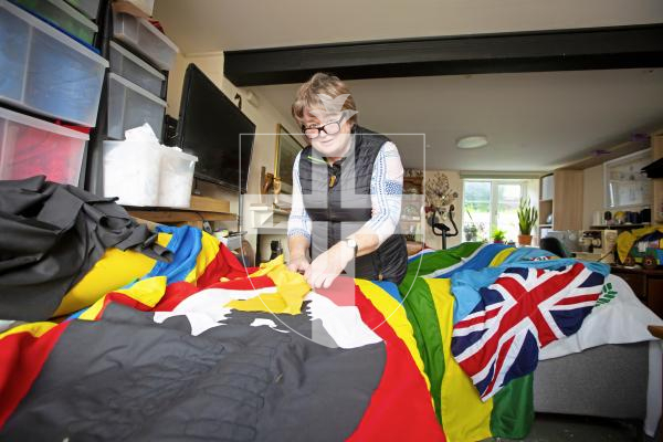 Picture by Peter Frankland. 05-03-24 Rose Yates of Sarnia Flags is making the Commonwealth flags which will be flown from the Weighbridge mast on Monday. Here she is working on the Kingdom of Eswatini (formally Swaziland).