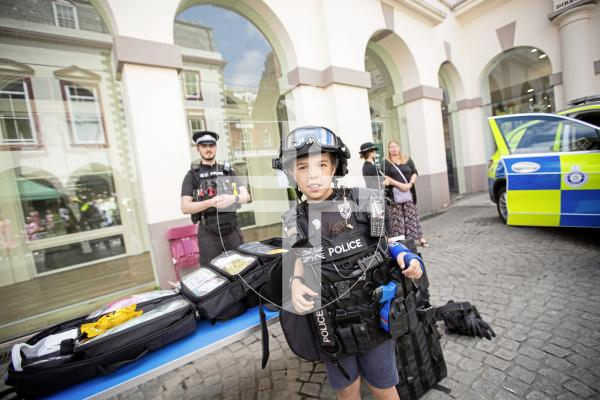 Picture by Sophie Rabey.  22-06-24.  Guernsey Bailiwick Law Enforcement held a Police recruitment drive in Market Square, showing off the different types of jobs you could work in within the police force.
Riley Robert (aged 9) trying on the police kit for size.