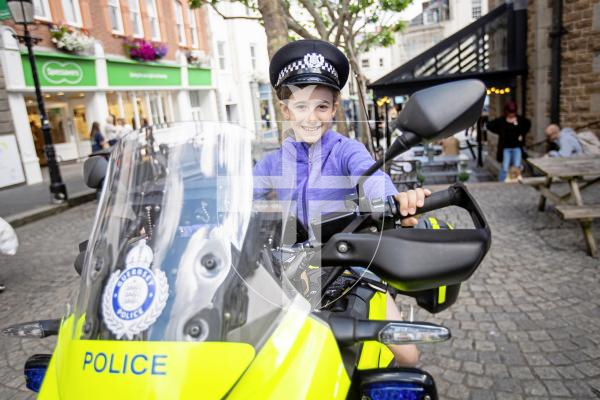Picture by Sophie Rabey.  22-06-24.  Guernsey Bailiwick Law Enforcement held a Police recruitment drive in Market Square, showing off the different types of jobs you could work in within the police force.
Faith Hughes (aged 9) on the police motorbike.