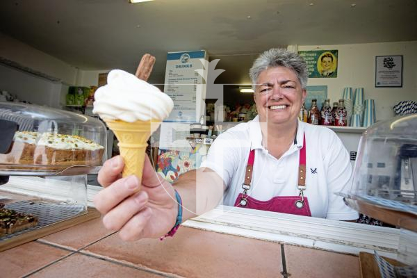 Picture by Erin Vaudin. 24-06-24 Bobbie Odoli works at Port Soif kiosk and is gearing up for a nice week of warm weather. But, the UK's heatwave might not make it this far south.
