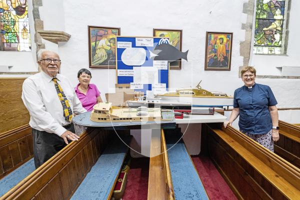 Picture by Sophie Rabey.  09-07-25.  Vale Church is holding a Sea Festival Weekend to raise money for the RNLI.  There will be a Tombola, Quiz, Ormer Treasure Trail and many other things for people to get involved with.
L-R John Bichard (maker of the model boats) and Pauline Bichard (organiser) with Church rector Bev Herve.