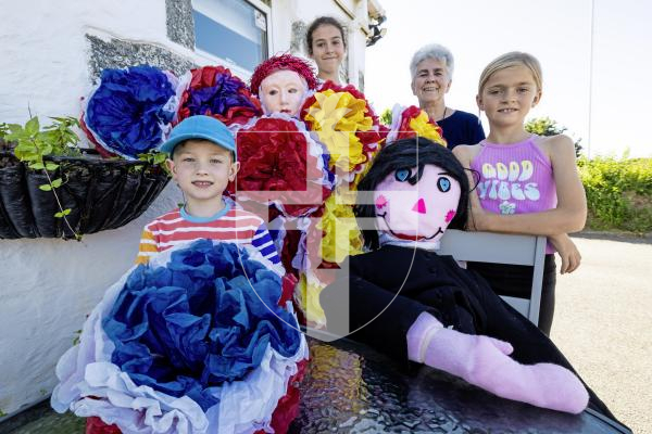 Picture by Peter Frankland. 12-07-25 Promo for next weeks Torteval Scarecrow Festival. L-R - James Attwooll, 7, Samantha Browning, 14, Sue Brooks and Ohlin Baudins, 9. Making the final prep.
The children are all part of the Torteval Youth Choir.