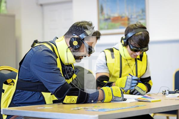 Picture by Sophie Rabey.  09-09-25.  A demonstration of the new Dementia Suits at Guernsey Alzheimer's Assocation.  
Guernsey Alzheimer's are introducing the suits conjunction with the Admiral Nurses to raise awareness of the physical challenges that people with dementia and old age might face in day to day tasks.  Luke Keohane from ITV and Ollie Guillou who hosts a Dementia Podcast undertake a series of different tasks for an experiment on ease.