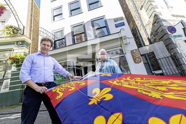 Picture by Peter Frankland. 10-09-25 Ruins of an old mill have been found during renovation work at No 1 Mill Street. L-R - Daniel Klaassen and David Savident with the 16th century standard of the King. It links No1 Mill Street with the Kings Mills in St Peter Port.