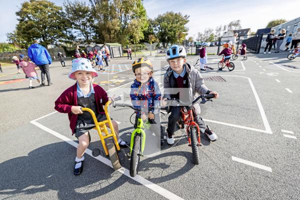 Picture by Sophie Rabey.  16-09-25.  La Mare De Carteret Primary School have had some new playground markings added over the summer break.  It was funded through the schools PTA and the Health Improvement Commission, with the hope to increase physical activity amongst the pupils and help their confidence on bikes etc.
L-R Isla Herve (5), CJ Wilson (4) and Oliver Brown (6)