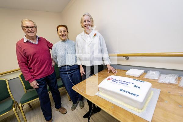 Picture by Sophie Rabey.   06-10-25.  Celebrating 5 years of Parkinsons Guernsey with speeches and cake at KGV.
L-R Peter Neville (Parkinson's Guernsey Chair), Mélanie Hardouin (Parkinson's Guernsey Chief Executive) and Louise Cripwell (Parkinson's Guernsey Patron).