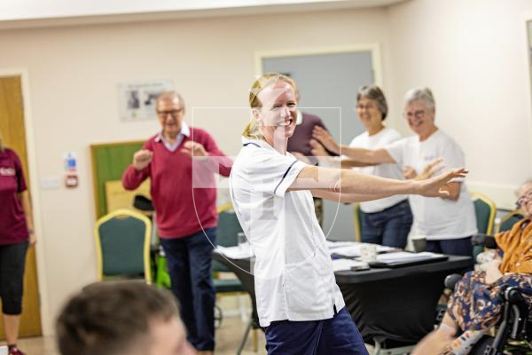 Picture by Sophie Rabey.   06-10-25.  Celebrating 5 years of Parkinsons Guernsey with speeches and cake at KGV.
Michelle Young from the Guernsey Therapy Group Neuro Outpatient Physio Team giving some key exercises.