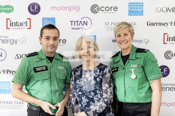 Picture by Sophie Rabey.  18-10-25.  Pride of Guernsey Awards 2025 at St Pierre Park.  Winner of Carer of the Year – St John Event First Aiders Josh Bonsall and Karen Brehaut with sponsor Dame Mary Perkins - Specsavers.