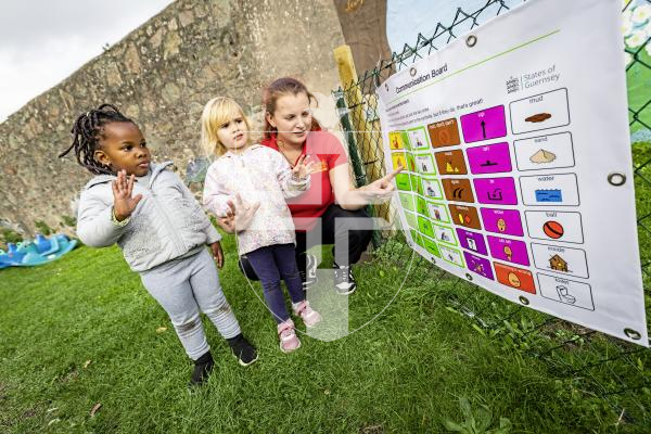Picture by Sophie Rabey.  21-10-25.  The States Early Years Team have funded a Communication Board for all Early Years settings in Guernsey and Alderney.   Children at Little Angels nursey using the board.
L-R Bianca Kato (3), Freja Manganaro (2) with staff member Abigail Corbet, signing stop.