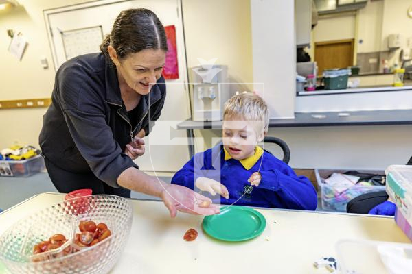 Picture by Sophie Rabey.  23-10-25.  ‘Munchy Lunches’ at Le Rondin Primary School.  The initiative was formed after a trial funded by the Health Improvement Commission in the 2024 summer term where fortnightly vegetables were supplied.   
After seeing the benefits to the pupils, the school decided to continue the initiative and increase provision so that pupils can try veg every day of the week.
School Nurse Chantelle Gilman with Bodhi Le Patourel (aged 8).