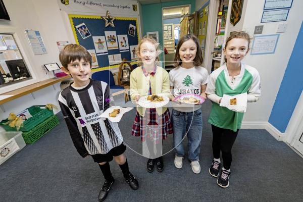Picture by Sophie Rabey.  20-11-25.  To celebrate World Childrens Day, St Martins Primary School had a full day of activities based around this years theme of 'multiculture'.
Different cultural foods including Guernsey Gache Melee, New Zealand Maori Hangi and Lebanese delights.
L-R Toby Mullin (9), Mollie Boatwright-Smith (9), Juno Bamford (8) and Ava Marley (8).