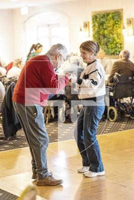 Picture by Sophie Rabey.  02-12-25.   Dementia Friendly, Boogie in the Bar" at The Penninsula Hotel.  This christmas social event is organized by Dementia Friendly Guernsey for people with dementia, their families, and carers, featuring familiar music, gentle dancing, refreshments, and conversation.
David Tostevin (from Saumarez Park Manor) enjoying a dance with Donna Haines.