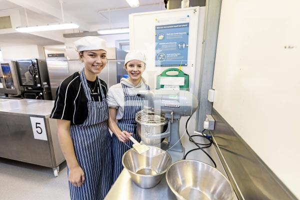 Picture by Sophie Rabey.  04-12-25.  A group of students from The Guernsey Institute (Coutanchez Campus) have chosen to hold a bake sale to raise money for the Toy and gift appeal. 
L-R Evelyn Ozanne (16) and Hannah Falla (16).