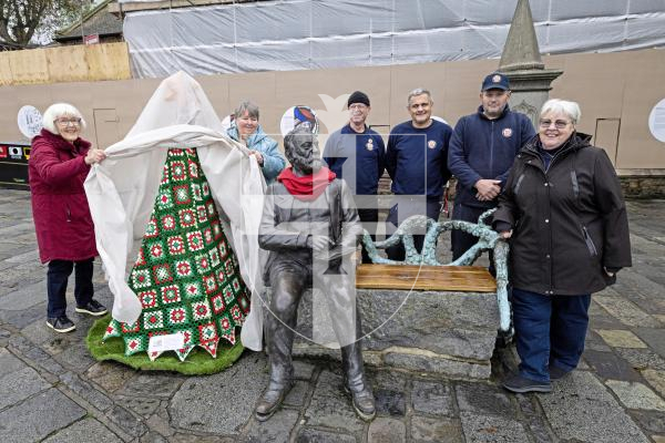 Picture by Peter Frankland. 08-12-25 A crocheted Christmas Tree made by the Women's Institute has been unveilled next to the Victor Hugo statue at the Town Church. L-R - Liz Walton and Rose Polli who helped with the knitting. Chris Inder, Stuart Page and Dillon Indge are members of the St Peter Port Constables grounds team who put the frame and stand together and Diane Mitchell, St Peter Port Constable.