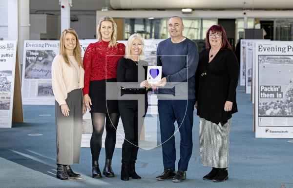 Picture by Peter Frankland. 10-12-25 Changes at Wessex Heartbeat with Tina Tolley retiring after many years. L-R - Anna Malcolm, Amelia Firetto, Tina Tolley, James Falla and Yvonne Blundell. Presenting a 'heart' to The Guernsey Press in recognition of the exposure the paper has given the charity.