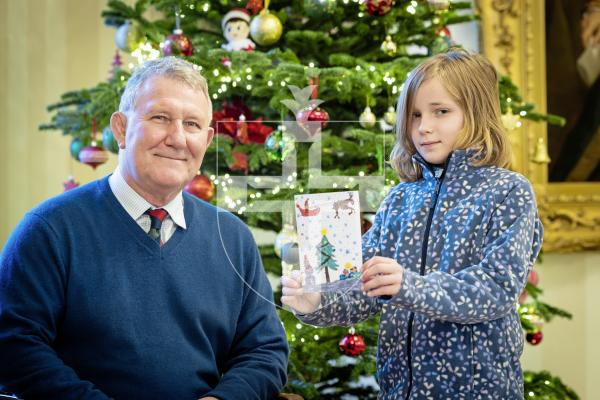 Picture by Peter Frankland. 10-12-25 Sir Richard Cripwell with Cressida Bryce, 9 from St Stephen's Brownies who has designed this year's Christmas card for Government House.