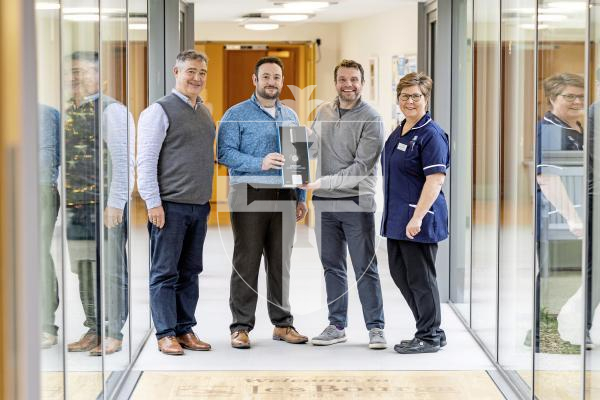 Picture by Sophie Rabey.  17-12-25.  Titan Wealth have given Les Bourgs Hospice a Stethoscope that can be used for nurses who have hearing deficiencies.  Jake Williams won this Angel of the Year 2025 in the GP Pride of Guernsey Awards, sponsored by Titan Wealth.
L-R Rob Jones (Les Bourgs Hospice CEO), Jake Williams (Pride winner), Robin Newbould (CEO of Titan Wealth) and Letishia Vermeulen (Head of nursing at Les Bourgs Hospice).