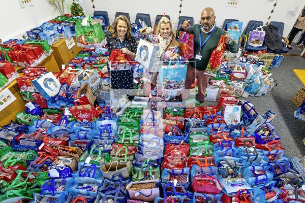 Picture by Peter Frankland. 17-12-25 Many bags of presents are now ready to be delivered community service users by the charity Gifts for the Elderly and Vunerable. L-R - Michelle MacMurray, Community Health Manager, Donna Patch, organiser and founder of Gifts for the Elderly and Vunerable and Collin Moodley, Social Care Team Co-ordinatior.