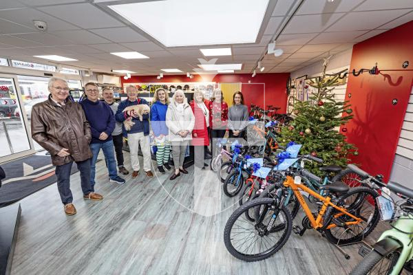 Picture by Sophie Rabey.  18-12-25.   Trustees of the Sarah Groves Foundation gathered at Ian Brown's Cycle Shop to handover 32 bikes for children to representatives of various agencies on island that have families who could benefit from them.  
Sarah Groves Trustees, Peter Morrey, Ken Acott, Paul Brehaut (Ian Brown), Vic Groves, Ally de Carteret (home start), Kate Groves, Kay Lindsay (Kindred Family Hub), Teresa Bott (Bright Beginnings) and Refuge Manager at Safer.
