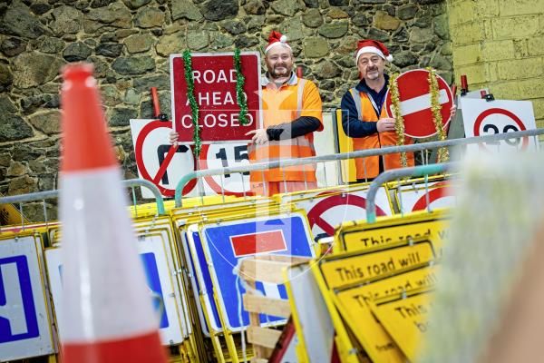 Picture by Peter Frankland. 22-12-25 At Christmas most of the States' road signs get a well deserved week off. L-R - Andy Brown, Signs and Lines Supervisor and Milton Le Moignan, Service Manager.