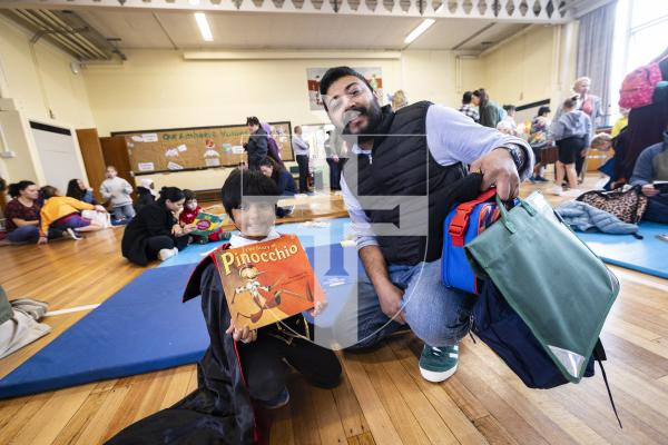 Picture by Sophie Rabey.  05-03-26.  KMPG continue to support early reading skills for young learners of World Book Day.  They have been supporting Amherst Primary Schools for many years and visit the school every week to provide one-to-one reading support.  Today they opened up the school hall to allow students to bring in their parents and enjoy time to read together.
L-R Usel Basnayake (4) with his dad Saiya Basnayake.
