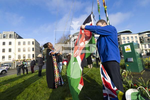 Picture by Peter Frankland. 09-03-26 Commonwealth Day flag raising at Weighbridge Roundabout. Ruth Mwaura raises some of the flags, including Kenya, where she is from.