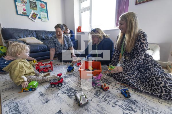 Picture by Peter Frankland. 11-03-26 Kindred Family Hub at Les Genats Estate. They are launching a project called 'Screens Away, Let's Play' which encourages youngester and parents to put their devices away and engage in real play. L-R - Alex Hawkins-Drew, Associate Director of Public Health, Ruth Sharp, Head of Early Years and Zara Betts, Paedeactric Therapist Speech and Language. With Koa Marsh, 2.