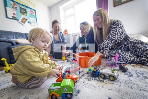 Picture by Peter Frankland. 11-03-26 Kindred Family Hub at Les Genats Estate. They are launching a project called 'Screens Away, Let's Play' which encourages youngester and parents to put their devices away and engage in real play. L-R - Alex Hawkins-Drew, Associate Director of Public Health, Ruth Sharp, Head of Early Years and Zara Betts, Paedeactric Therapist Speech and Language. With Koa Marsh, 2.