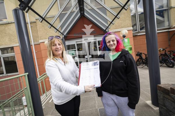 Picture by Sophie Rabey.  30-04-26. Bernie Coutu with her daughter, Koritta Coutu, handing in a petition to Frossard House.  The Bridge Neighbourhoood Watch has petitioned to get the hut back on Northside.