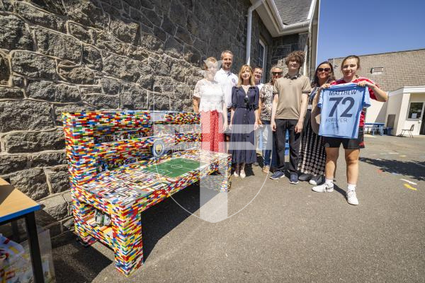 Picture by Sophie Rabey.  03-07-26.   The Priaulx Premature Baby Foundation unveiled a life-size LEGO bench at St Martin’s Primary School today, to honour the memory of the late Matthew Girard who died of Cancer at the age of 12 in 2020.  
The charity has been working closely with his mum, Sarah Girard, to create something special for the school community in recognition of his love for LEGO.   
L-R  Sarah Girard (Matthews mother), Peter Beausire (PPBF Trustee), Sammy Meerveld (PPBF Project Manager), Thomas Hearne (built the bench framework), Koby Meerveld (16) and Barbara Crowson (who helped build the bench), Clare Giles (St Martins headteacher) and Grace Girard (18, Matthews sister)