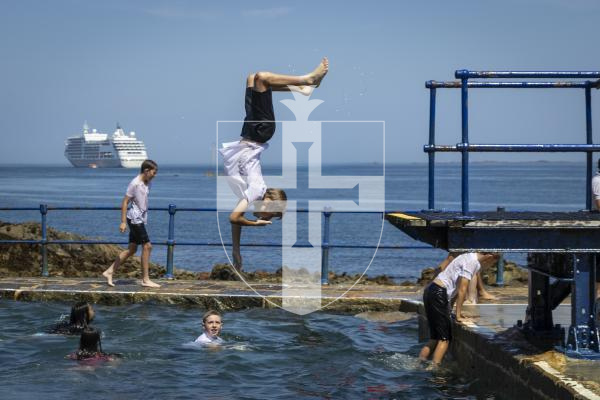 Picture by Christina Jones. 17-07-26 Yr six Vauvert School pupils jump into the water at The Bathing Pools to celebrate finishing their time at the school.