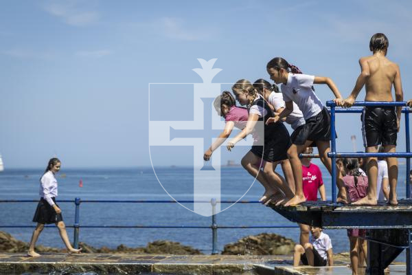 Picture by Christina Jones. 17-07-26 Yr six Vauvert School pupils jump into the water at The Bathing Pools to celebrate finishing their time at the school.