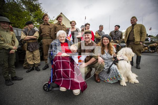 Picture by Sophie Rabey.  06-05-24.  The Guernsey Military Vehicle Group visited 104-year-old Helene Gallienne today at her home, ahead of Liberation Day.
L-R Helene Gallienne, Mat Broughton, Karen Broughton and dog  Kobe.